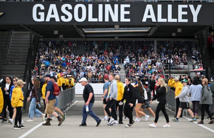 Fans walking under the gasoline alley sign at IMS